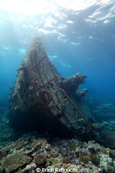 The broken bow of the Kormoran wreck and its coral garden. by Erich Reboucas 